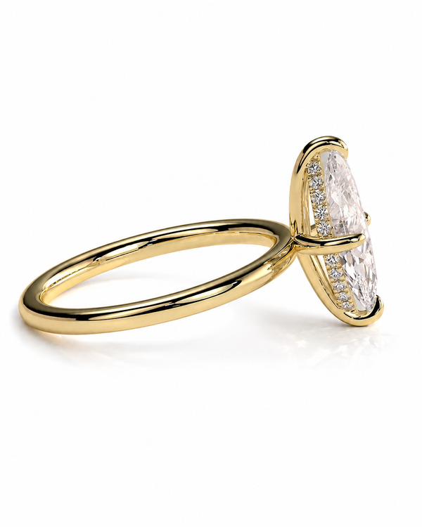 color_10K_YG, color_14K_YG &&A yellow gold ring featuring a marquise-cut clear gemstone in a prong setting, accented with small pavé diamonds along the sides, shown on a clean white background.