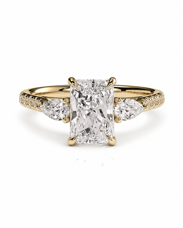 color_10K_YG, color_14K_YG &&A yellow gold diamond ring with a large rectangular center stone and smaller round and marquise side stones, set against a plain white background.