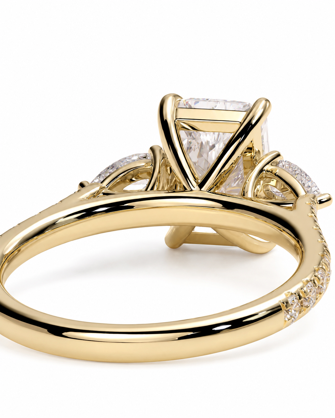 color_10K_YG, color_14K_YG &&A close-up shot of a yellow gold ring featuring a large rectangular clear gemstone in a prong setting, with smaller accent stones along the band, set against a plain white background.