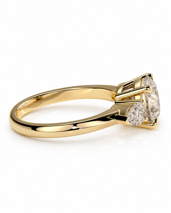 color_10K_YG, color_14K_YG &&A yellow gold solitaire engagement ring featuring a large round brilliant-cut center stone and smaller accent stones on the shoulders, set against a clean white background.