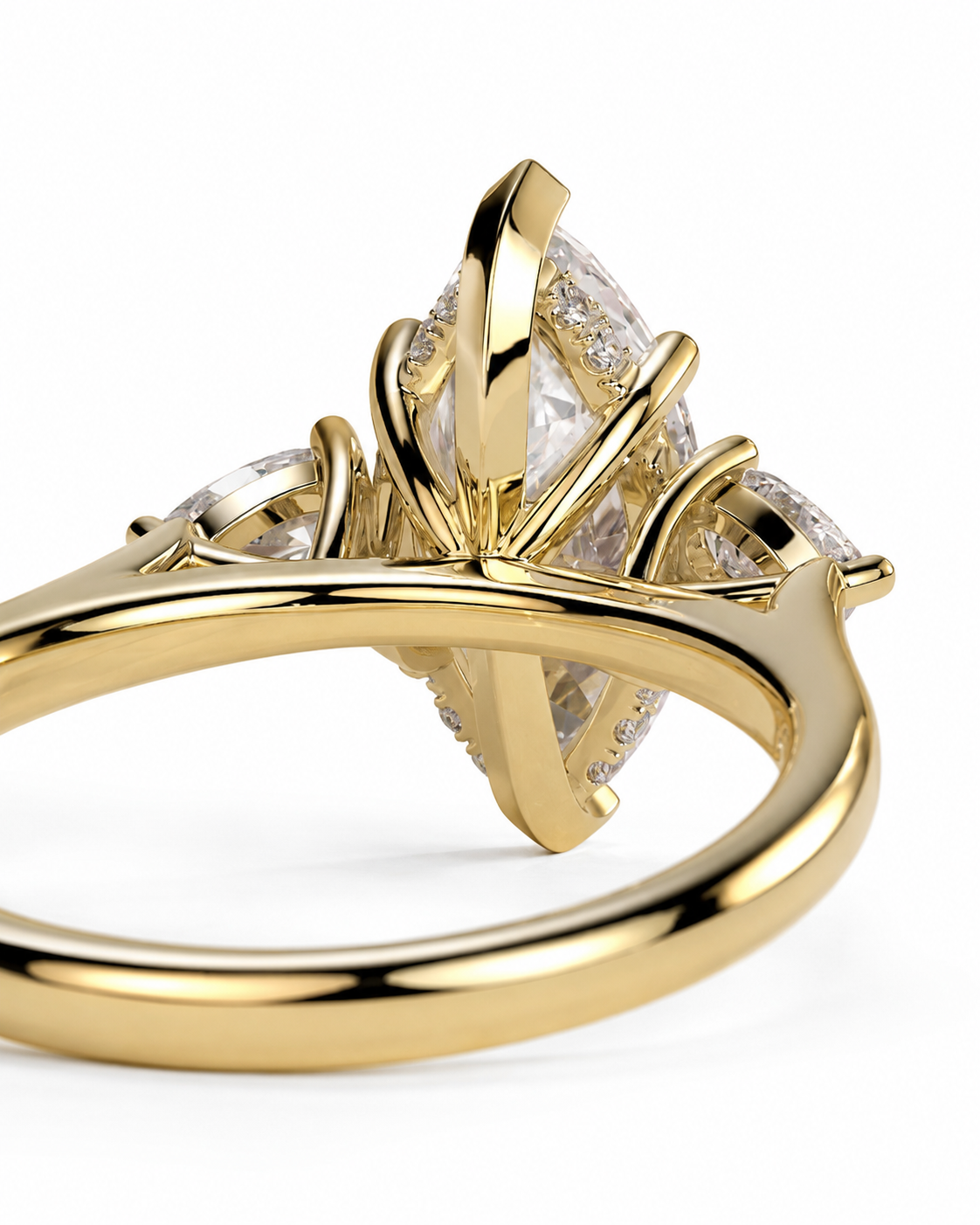 color_10K_YG, color_14K_YG &&A close-up shot of a yellow gold ring featuring a marquise-cut clear center stone and smaller side stones, set in a prong-style crown on a polished band.