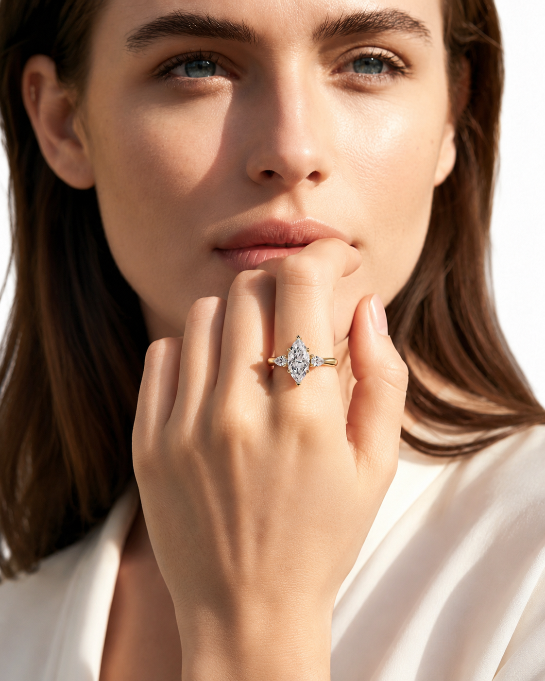 color_10K_YG, color_14K_YG &&A close-up lifestyle shot of a woman wearing a gold ring with a diamond cluster setting on her finger, set against a bright white background.