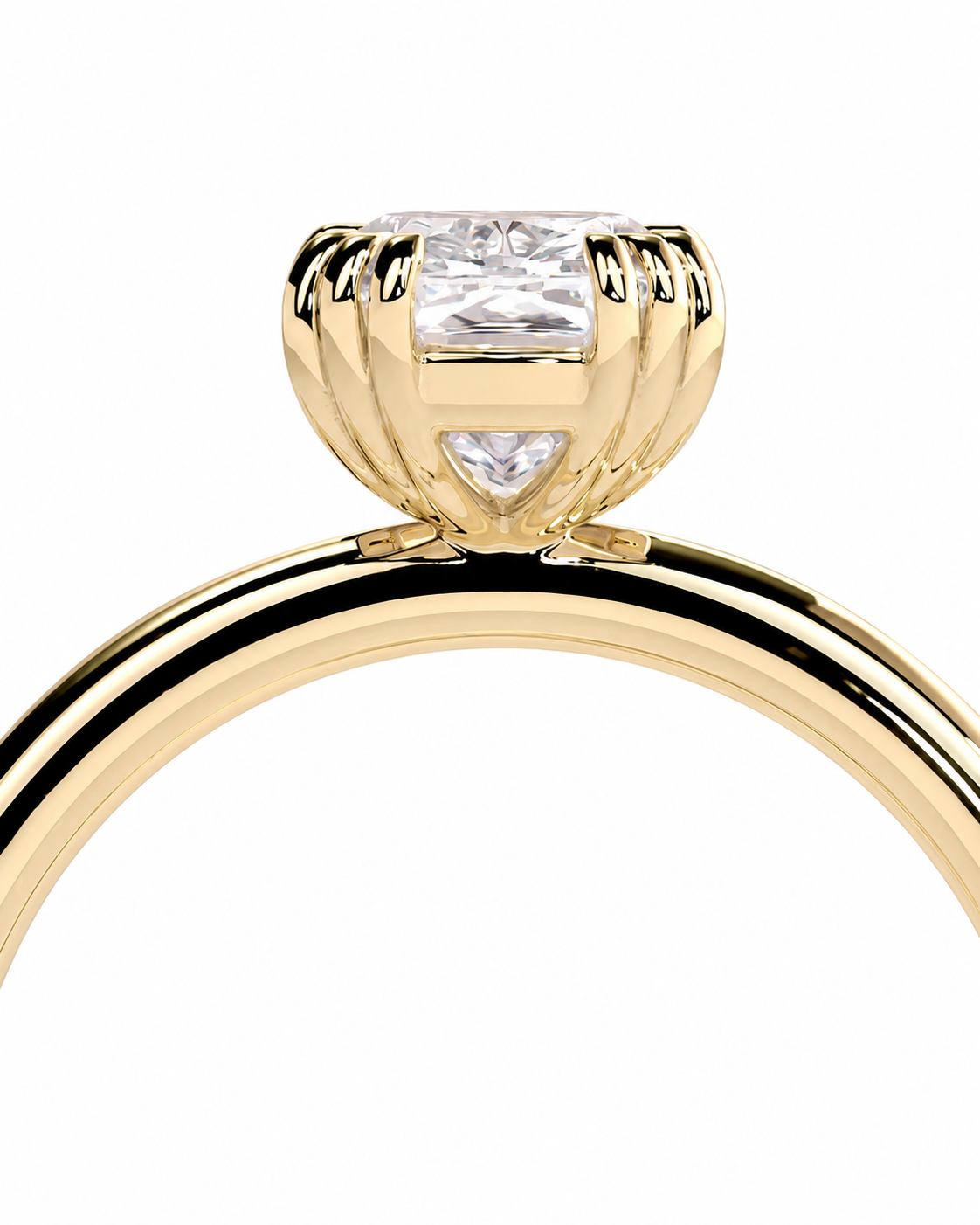 color_10K_YG, color_14K_YG &&A close-up of a yellow gold ring featuring a round brilliant-cut clear gemstone in a prong setting with a small triangular accent stone below, shown against a plain white background.