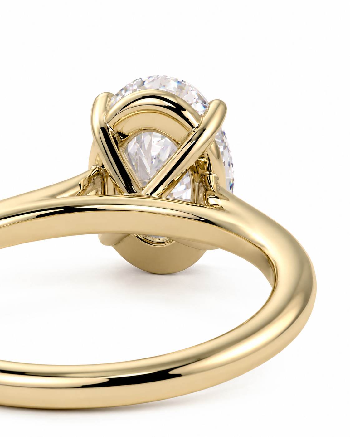color_10K_YG, color_14K_YG &&A close-up shot of a yellow gold ring featuring a pear-cut diamond center stone and smaller diamonds in a wrap-around setting, on a clean white background.