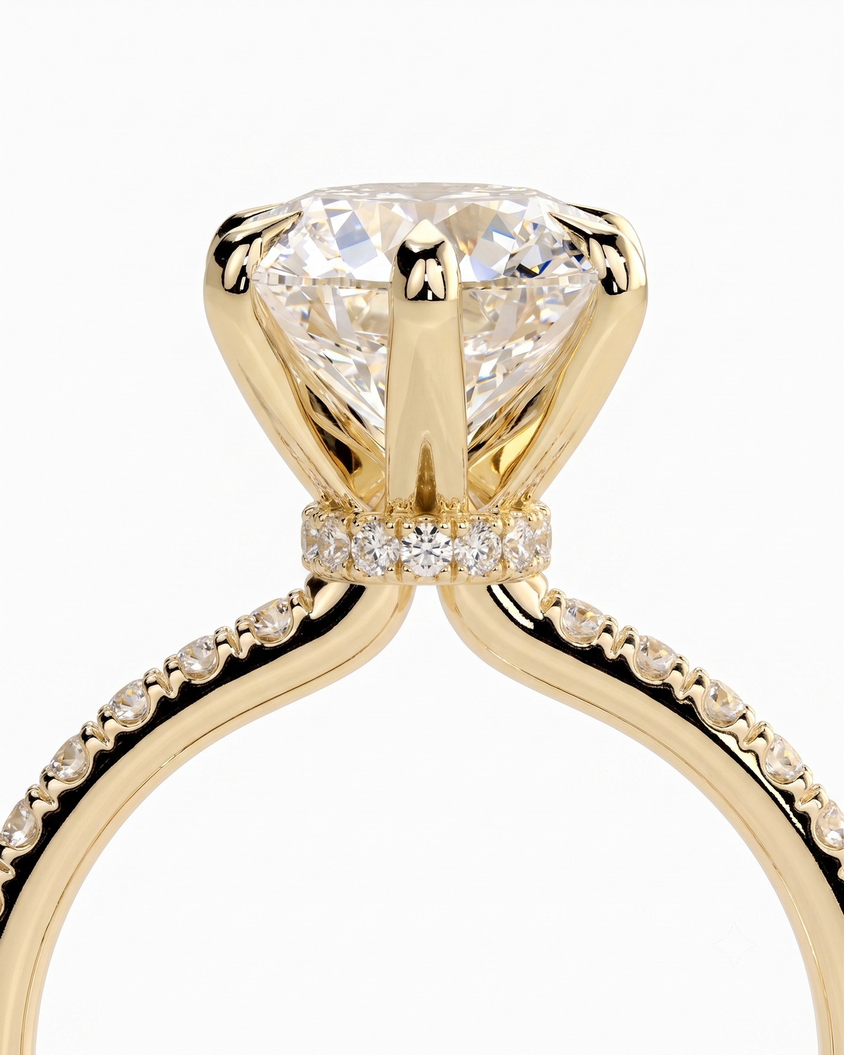 color_10K_YG, color_14K_YG &&A close-up of a yellow gold solitaire engagement ring featuring a large round brilliant-cut diamond center stone and a halo of smaller diamonds, set against a clean white background.