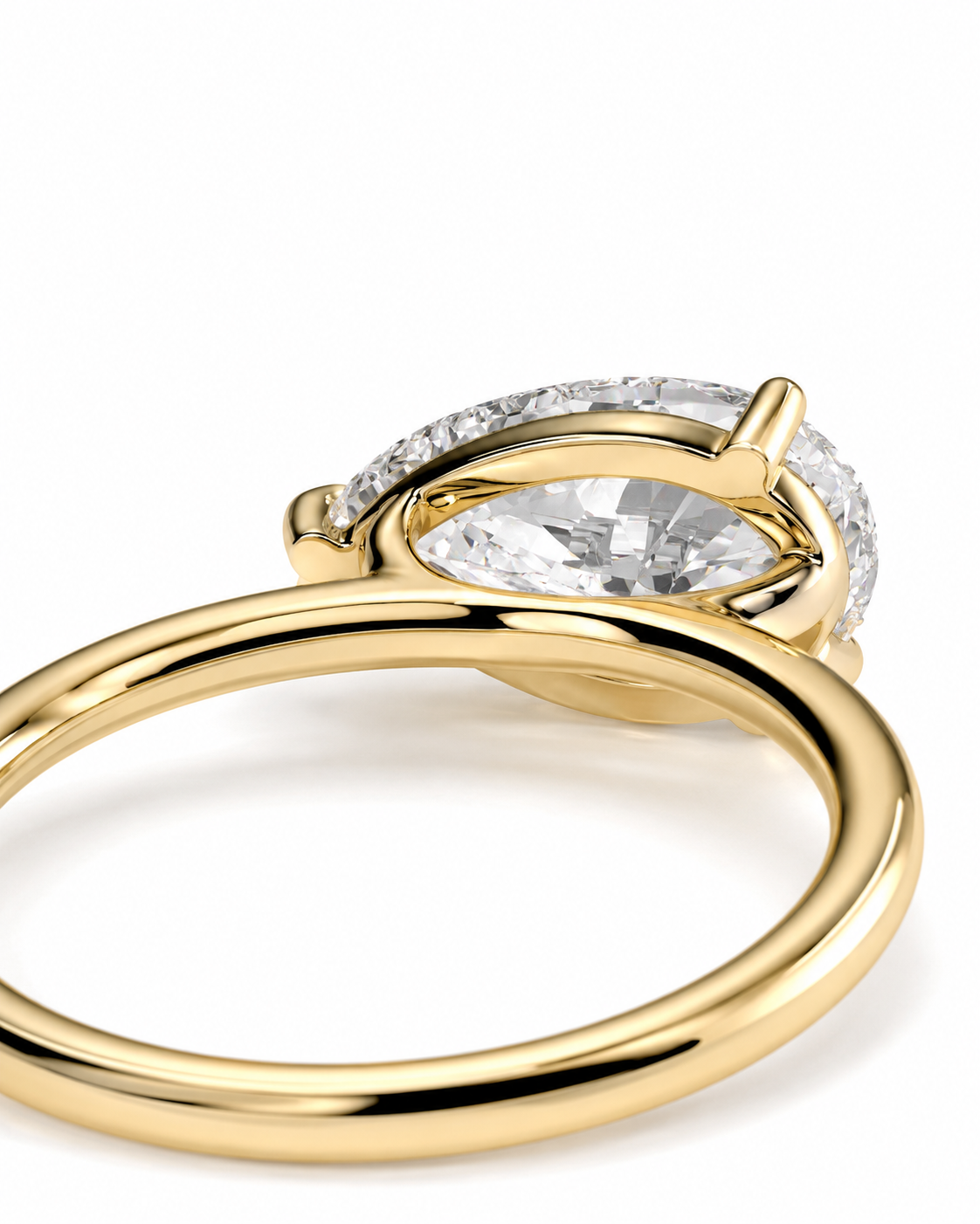 color_10K_YG, color_14K_YG &&
A close-up shot of a yellow gold ring featuring a marquise-cut clear gemstone in a prong setting, accented by a halo of small round diamonds, on a clean white background.