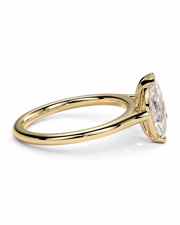 color_10K_YG, color_14K_YG &&A yellow gold ring featuring a marquise-cut clear gemstone in a four-prong setting, shown from a side angle on a clean white background.
