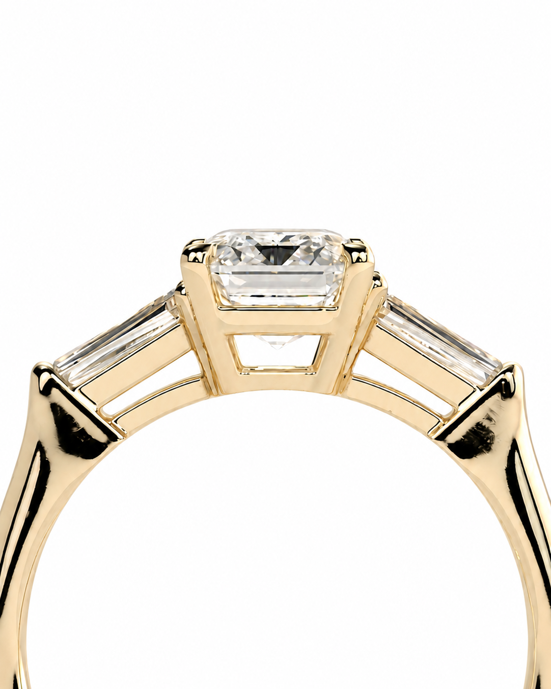 color_10K_YG, color_14K_YG &&A close-up of a yellow gold ring featuring a central rectangular clear gemstone in a prong setting, with three baguette-cut side stones on a white background.