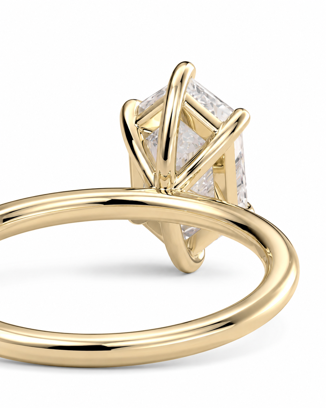 color_10K_YG, color_14K_YG &&
A close-up shot of a yellow gold ring featuring a rectangular clear gemstone in a unique crisscross prong setting, shown against a plain white background.