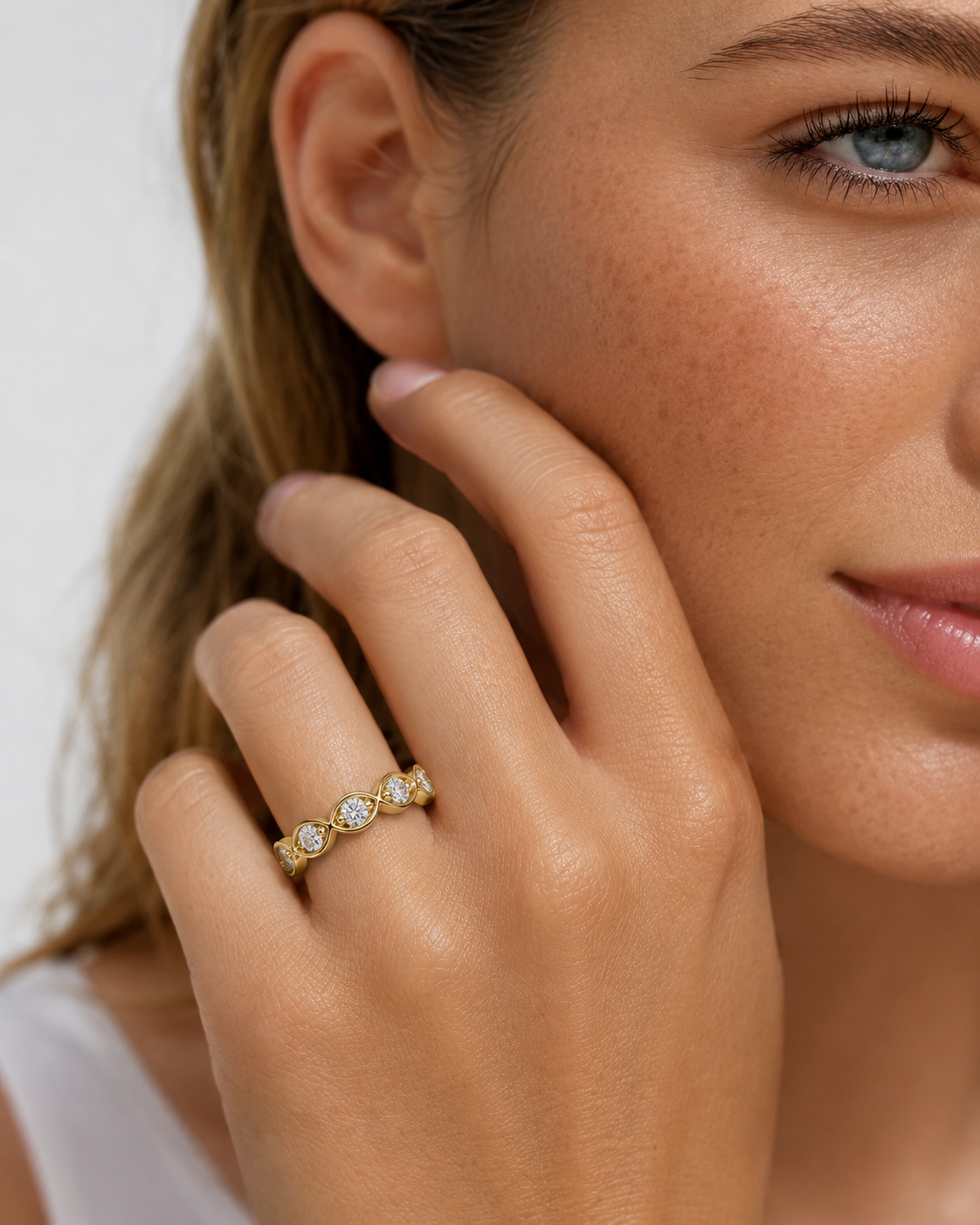color_10K_YG, color_14K_YG &&Close-up of a women's moissanite wedding band with polished marquise-style settings.