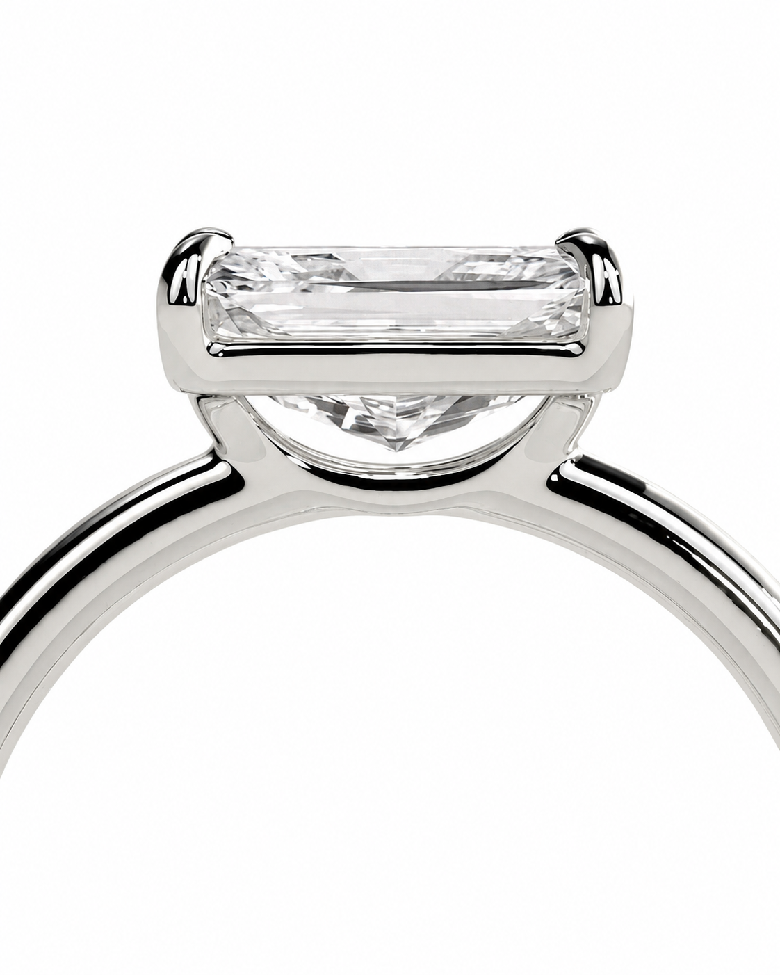 color_925_SIL,color_935_ARG,color_10K_WG, color_14K_WG &&
A close-up of a silver-toned solitaire engagement ring featuring a rectangular baguette-cut clear gemstone in a four-prong setting, shown against a plain white background.