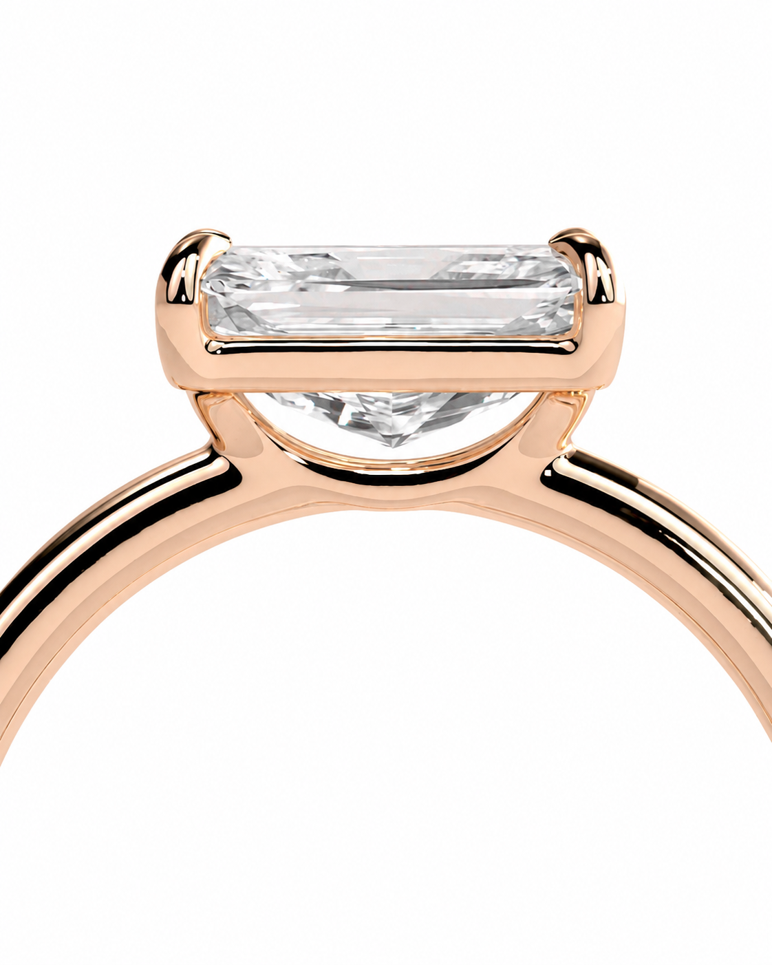 color_10K_RG, color_14K_RG &&
Close-up of a rose gold ring with a rectangular baguette-cut clear gemstone in a four-prong setting, shown against a plain white background.