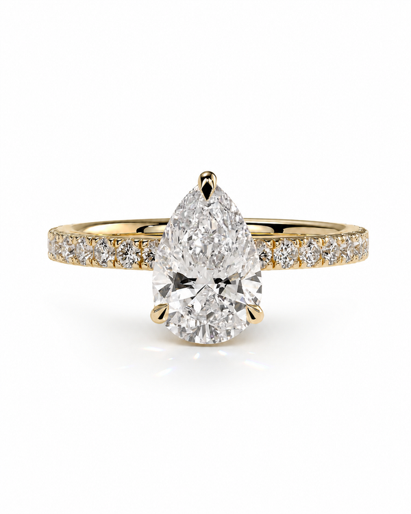 color_10K_YG, color_14K_YG &&A pear-cut diamond engagement ring in yellow gold with a pavé band, set against a clean white background.