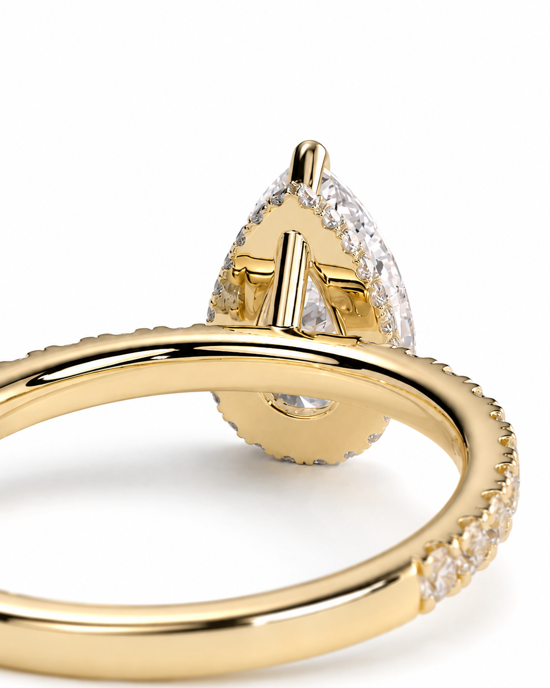 color_10K_YG, color_14K_YG &&Close-up of a gold ring with a teardrop-shaped clear gemstone and small pavé-set stones along the band, photographed on a white background.
