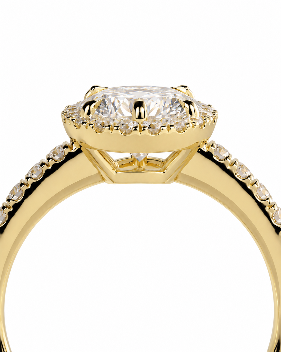 color_10K_YG, color_14K_YG &&A close-up shot of a yellow gold ring featuring a cushion-cut center stone surrounded by a halo of small diamonds, with a pavé diamond band, set against a plain white background.