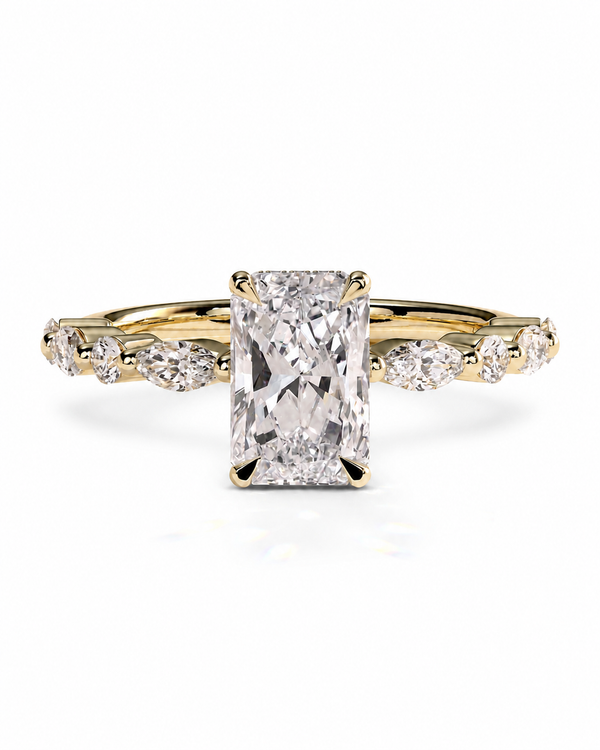 color_10K_YG, color_14K_YG &&A yellow gold engagement ring featuring a large rectangular radiant-cut diamond center stone, accented by smaller round and marquise-cut diamonds along the shoulders, set against a clean white background.