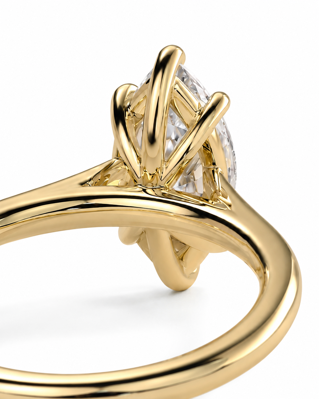 color_10K_YG, color_14K_YG &&A close-up of a yellow gold ring featuring an marquise-cut clear gemstone in a unique multi-prong setting, shown on a clean white background.