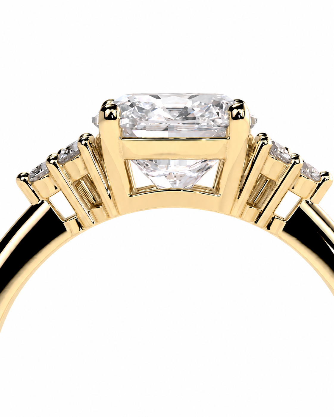 color_10K_YG, color_14K_YG &&A close-up of a yellow gold ring featuring a large rectangular clear center stone with smaller accent stones on either side, set against a plain white background.