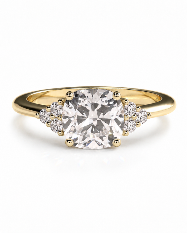 color_10K_YG, color_14K_YG &&A yellow gold ring featuring a large cushion-cut center diamond flanked by small round diamonds on the shoulders, set against a clean white background.