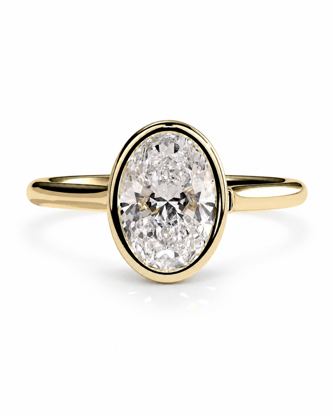 color_10K_YG, color_14K_YG && yellow gold ring featuring an oval-cut clear gemstone in a bezel setting, shown against a plain white background.
