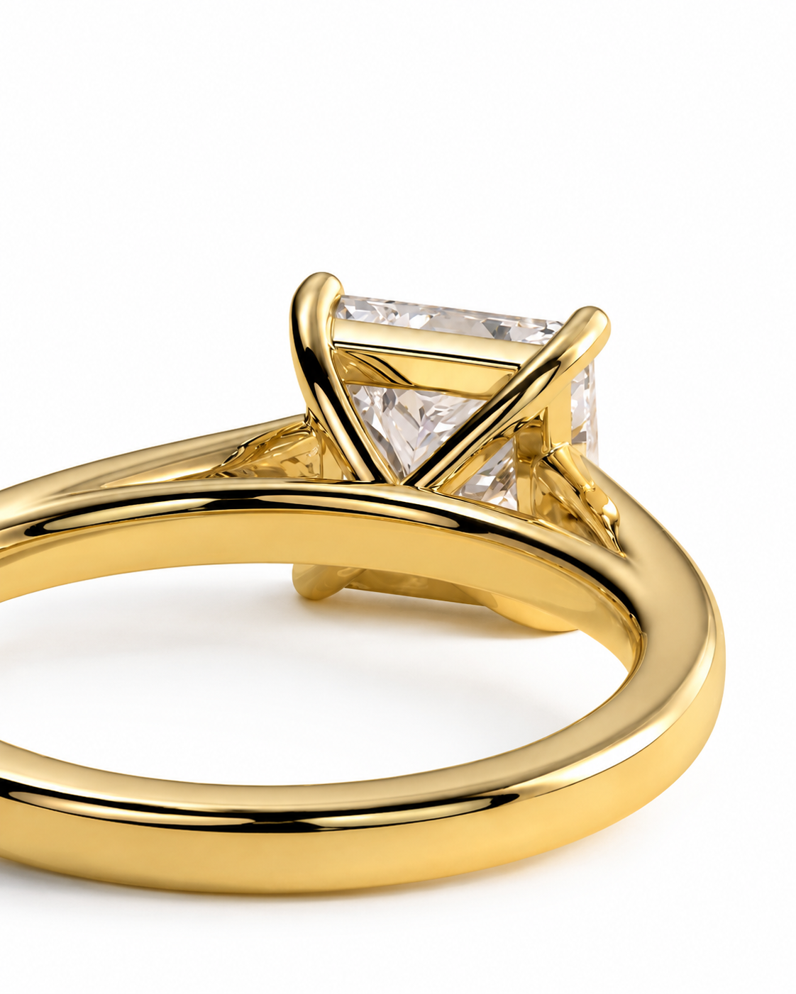 color_10K_YG, color_14K_YG &&A close-up shot of a yellow gold ring featuring a rectangular clear gemstone in a four-prong setting, shown against a plain white background.