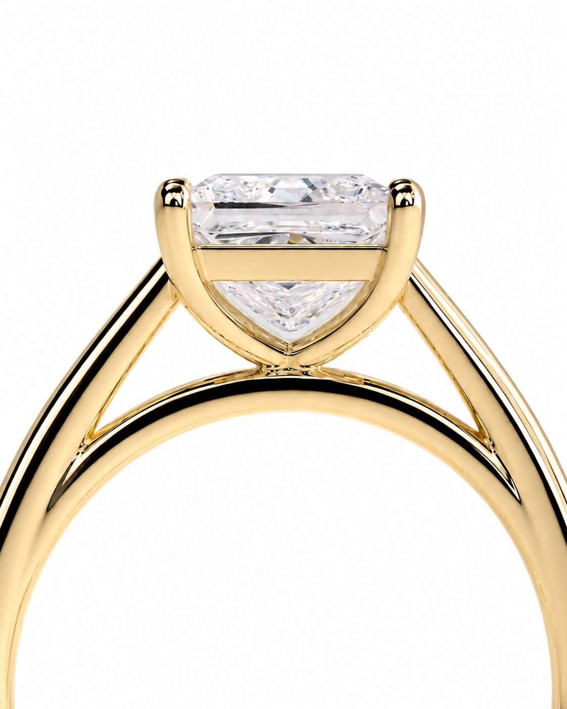 color_10K_YG, color_14K_YG &&A close-up shot of a yellow gold diamond ring featuring a triangular diamond-shaped setting with a rectangular baguette-cut diamond on top, set against a plain white background.