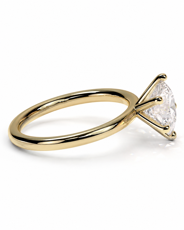 color_10K_YG, color_14K_YG &&A yellow gold solitaire engagement ring with a clear round-cut gemstone in a four-prong setting, shown on a clean white background.