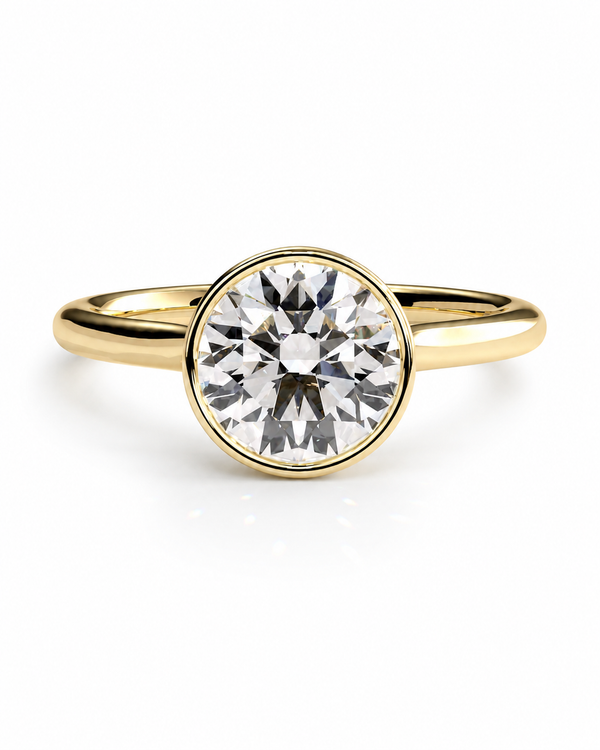 color_10K_YG, color_14K_YG &&A yellow gold solitaire engagement ring featuring a round brilliant-cut diamond set in a bezel setting, shown on a clean white background.