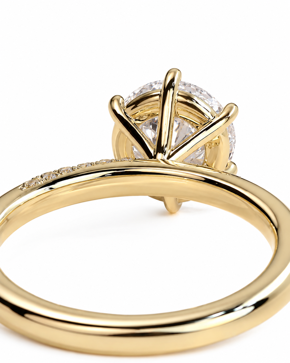 color_10K_YG, color_14K_YG &&A close-up shot of a yellow gold solitaire engagement ring with a round brilliant-cut diamond, set against a clean white background.