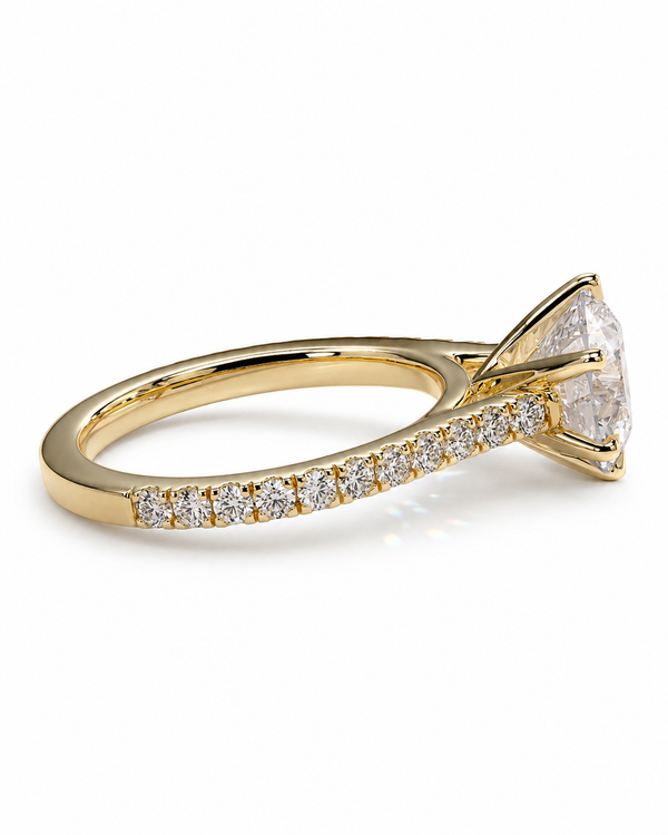 color_10K_YG, color_14K_YG &&A yellow gold diamond ring with a large round-cut center stone and a pavé band set with small diamonds, shown on a clean white background.