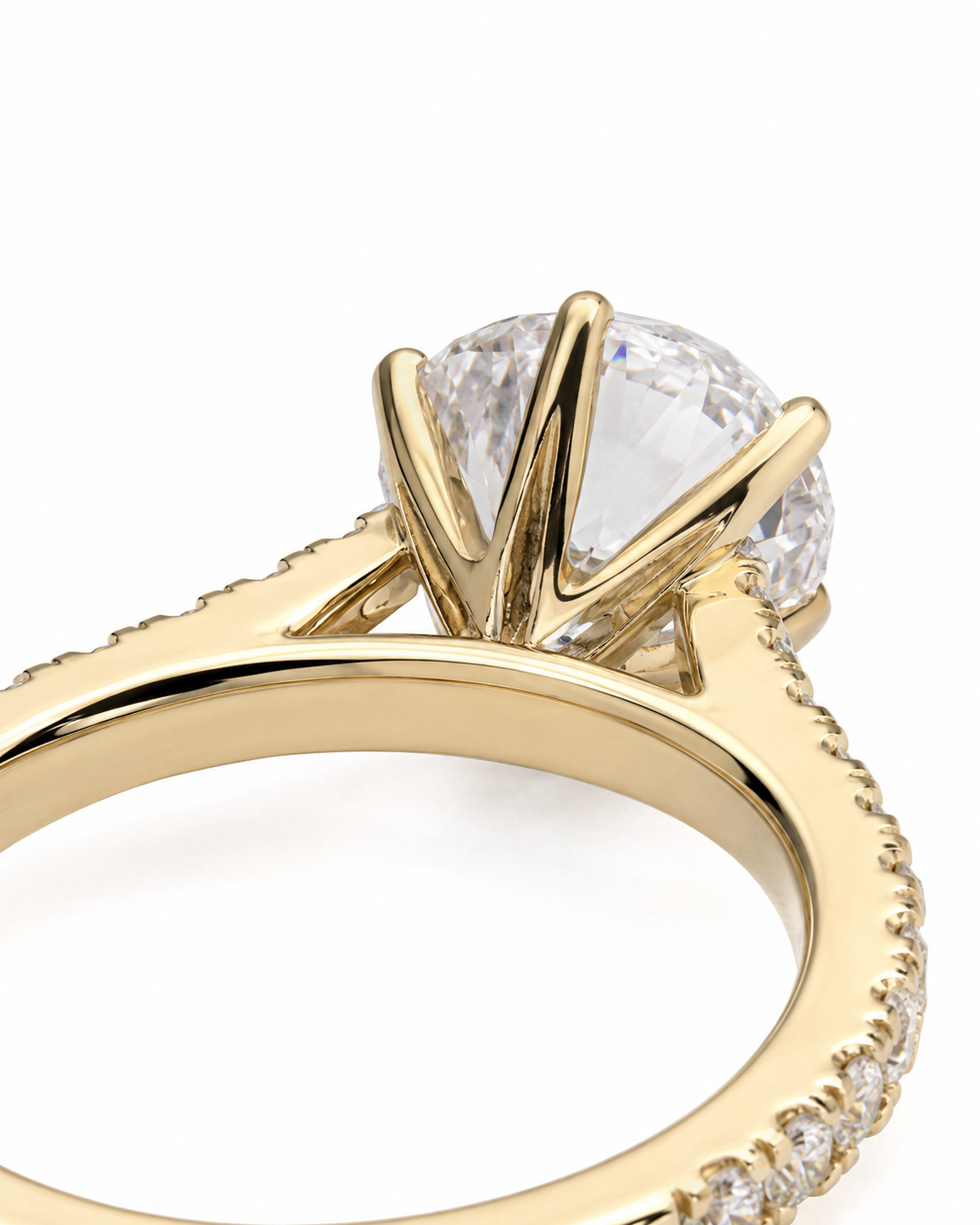 color_10K_YG, color_14K_YG &&A close-up shot of a yellow gold ring featuring a large round brilliant-cut clear gemstone in a prong setting, with a pavé band on the outer side, shown against a plain white background.