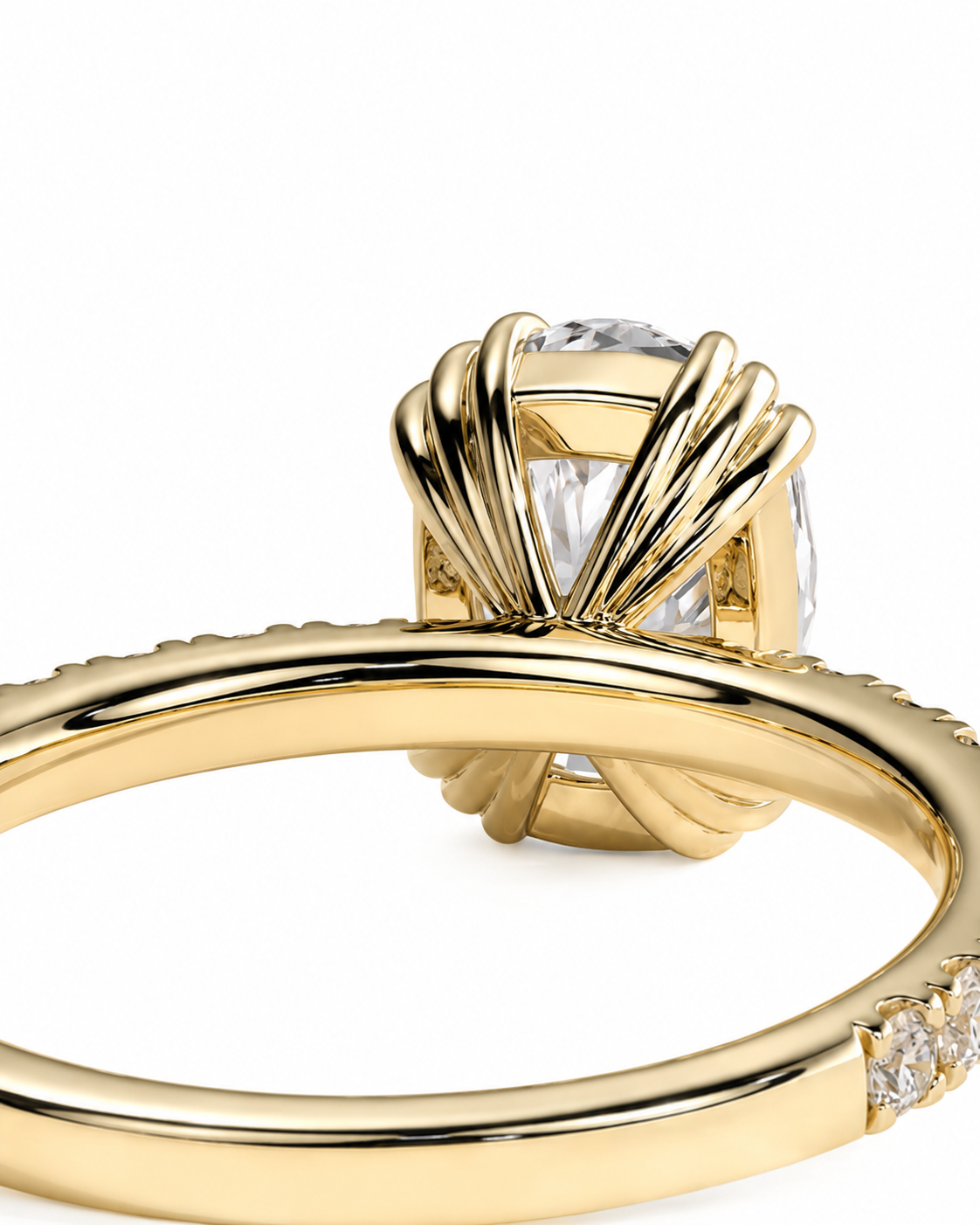 color_10K_YG, color_14K_YG &&A close-up of a yellow gold ring featuring a large clear cushion-cut center stone in a fan-like prong setting, with a thin pavé band on the shank, shown against a plain white background.