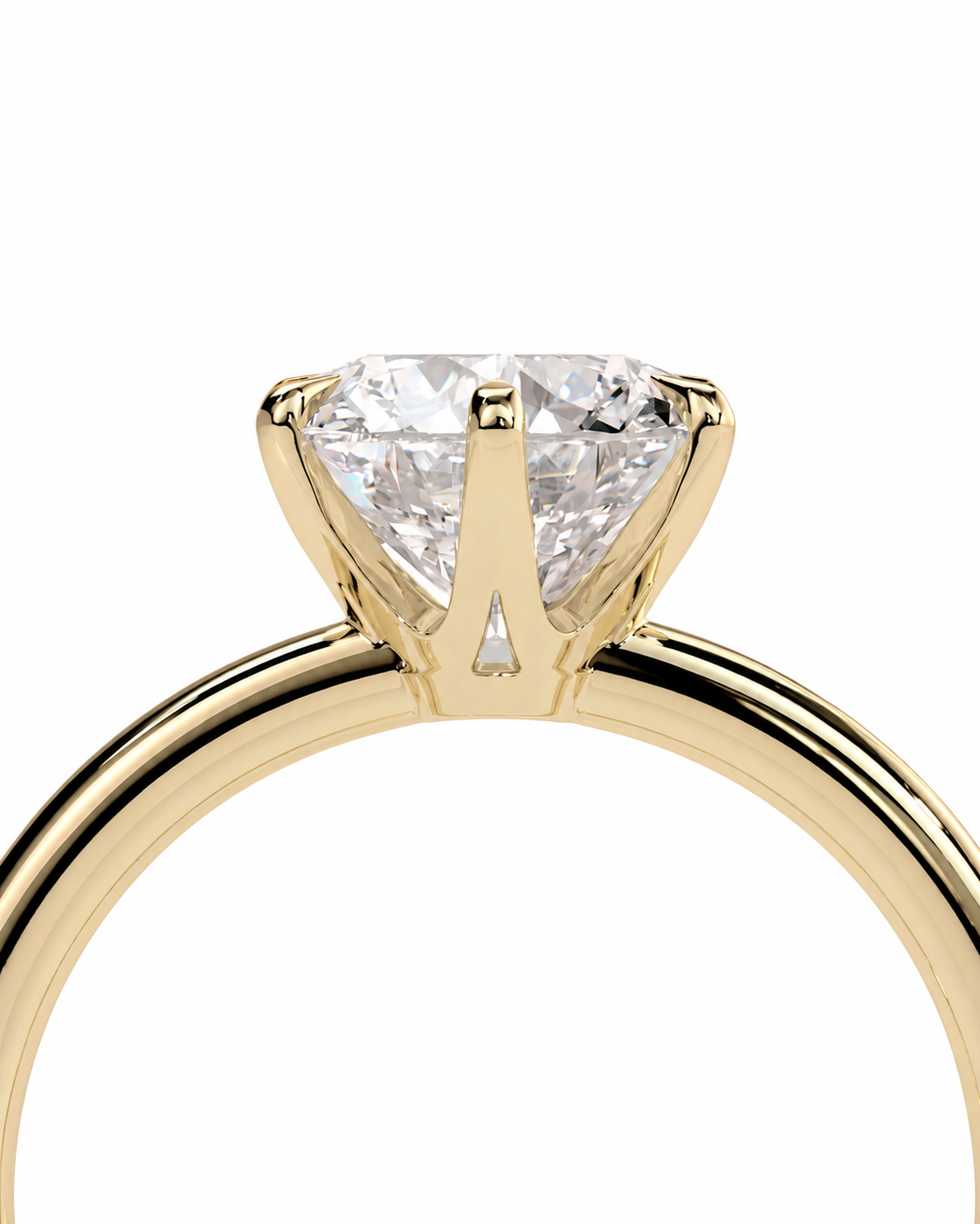 color_10K_YG, color_14K_YG &&A close-up of a yellow gold solitaire engagement ring featuring a brilliant round-cut diamond set in a four-prong crown, shown against a solid white background.