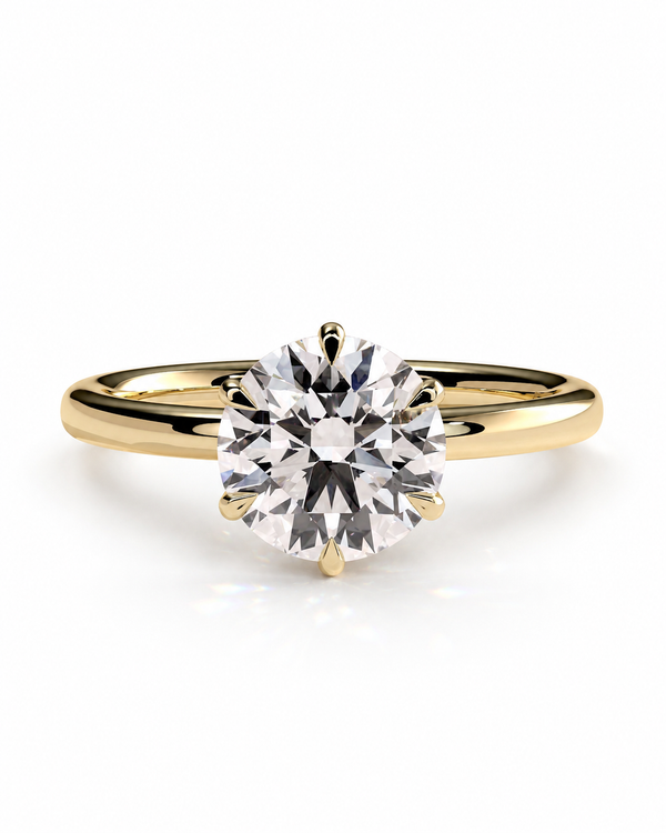 color_10K_YG, color_14K_YG &&A classic solitaire engagement ring featuring a round brilliant-cut diamond set in a yellow gold four-prong setting on a polished gold band, shown against a clean white background.