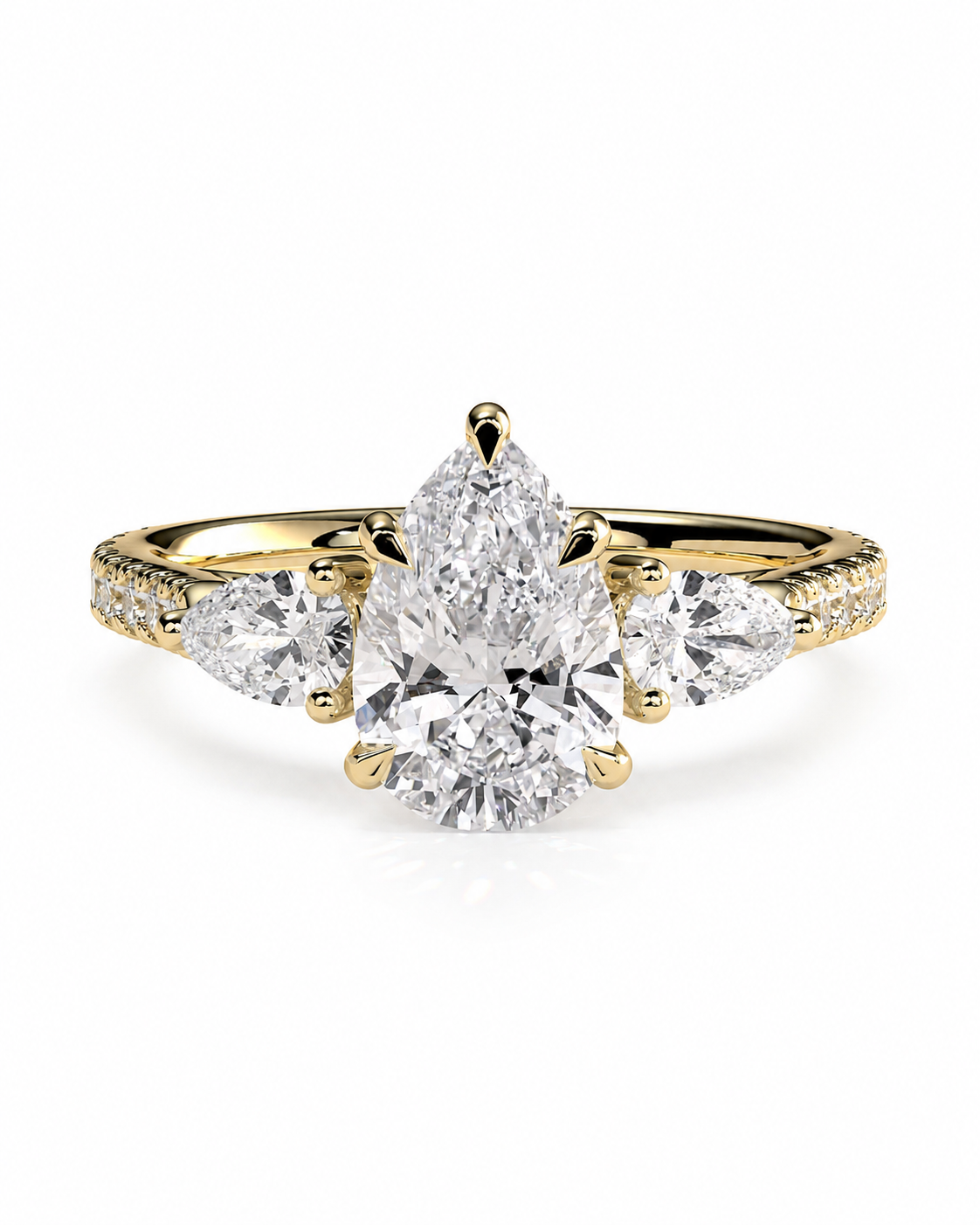 color_10K_YG, color_14K_YG &&A yellow gold ring featuring a pear-cut center diamond flanked by two round diamonds, with small pavé diamonds along the shoulders, set against a plain white background.