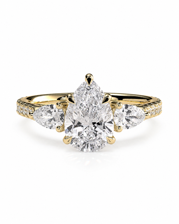 color_10K_YG, color_14K_YG &&A yellow gold ring featuring a pear-cut center diamond flanked by two round diamonds, with small pavé diamonds along the shoulders, set against a plain white background.