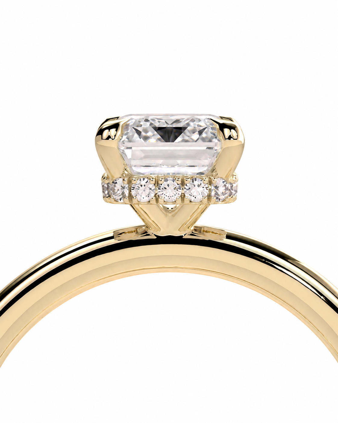 color_10K_YG, color_14K_YG &&A close-up of a yellow gold ring featuring a large rectangular clear center stone and a halo of small round diamonds on a white background.