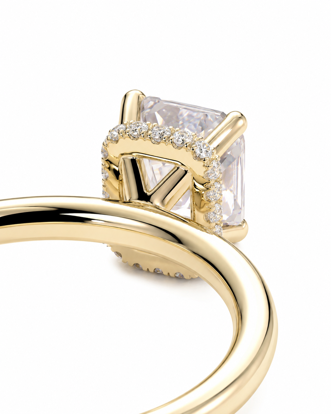 color_10K_YG, color_14K_YG &&A close-up of a yellow gold ring featuring a large rectangular clear gemstone in a prong setting, surrounded by small pavé-set clear stones, on a white background.