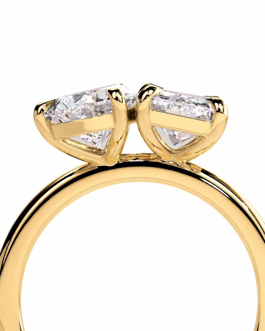 color_10K_YG, color_14K_YG &&A close-up of a yellow gold ring featuring two marquise-cut clear gemstones in a heart-like setting, shown against a plain white background.