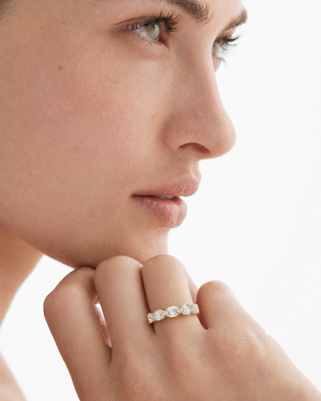 color_10K_YG, color_14K_YG &&Close-up of a women's moissanite eternity-style wedding band with marquise gemstones.