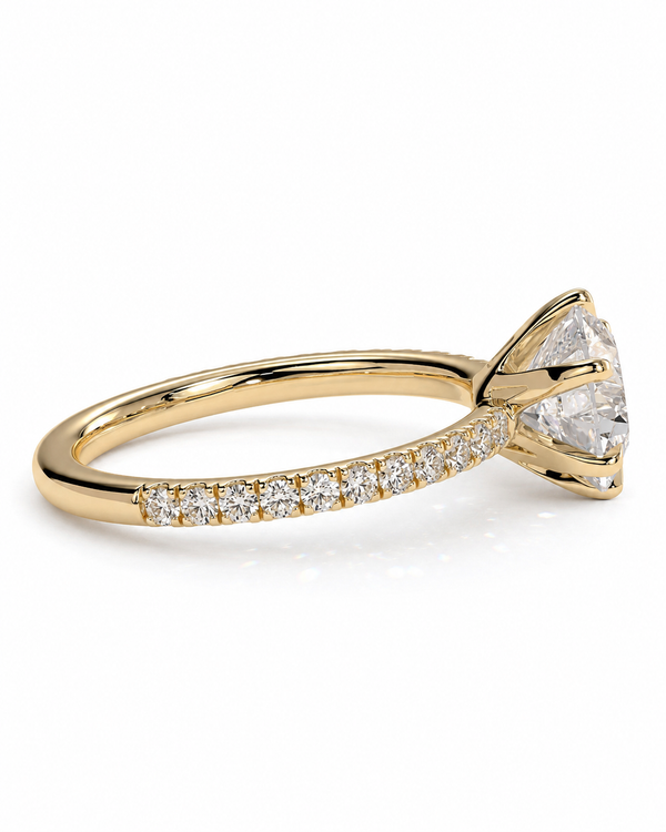 color_10K_YG, color_14K_YG &&A yellow gold solitaire engagement ring featuring a large round brilliant-cut center stone and a pavé band set with small round diamonds, shown on a clean white background.