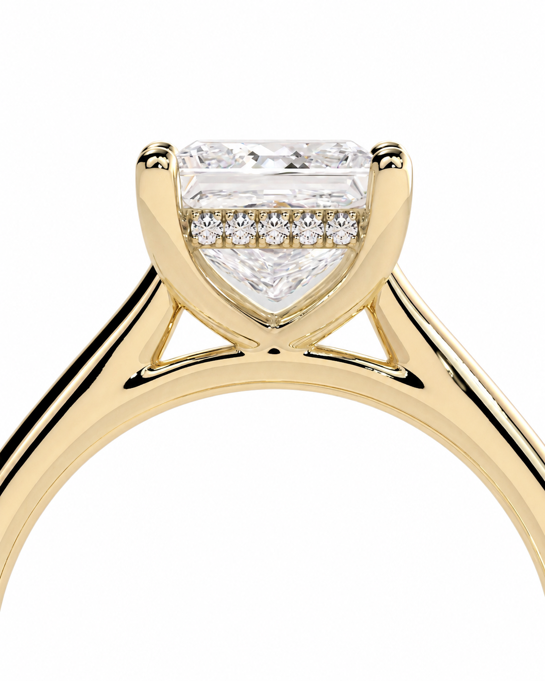 color_10K_YG, color_14K_YG &&A close-up of a yellow gold solitaire engagement ring featuring a large rectangular baguette-cut center diamond and a row of smaller round diamonds along the pavé band, set against a plain white background.