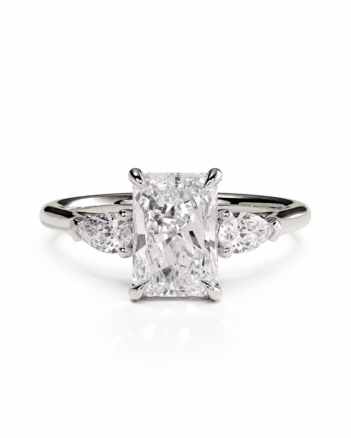 color_925_SIL,color_935_ARG,color_10K_WG, color_14K_WG &&
An engagement ring featuring a rectangular radiant-cut center diamond set in a silver-colored metal band with three marquise-cut side diamonds, shown on a clean white background.