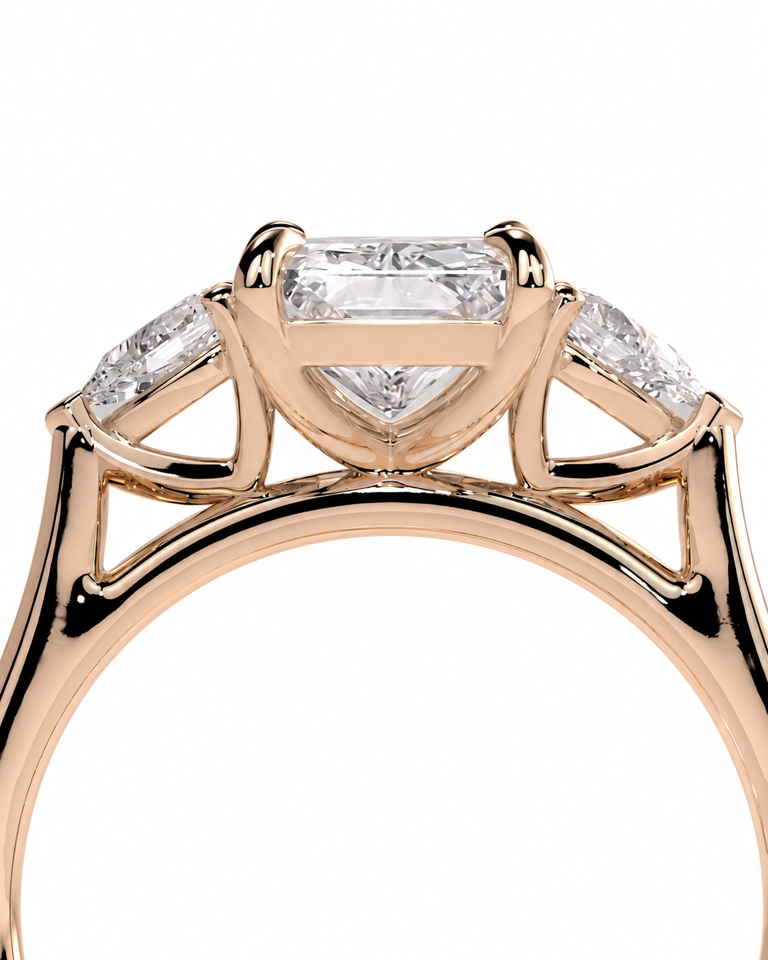 color_10K_RG, color_14K_RG &&
A close-up of a rose gold ring featuring a large rectangular baguette-cut center diamond, flanked by smaller round and rectangular side diamonds, set against a plain white background.