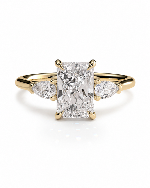 color_10K_YG, color_14K_YG &&A yellow gold ring featuring a large rectangular radiant-cut diamond center stone with two smaller marquise-cut diamonds on either side, set against a clean white background.