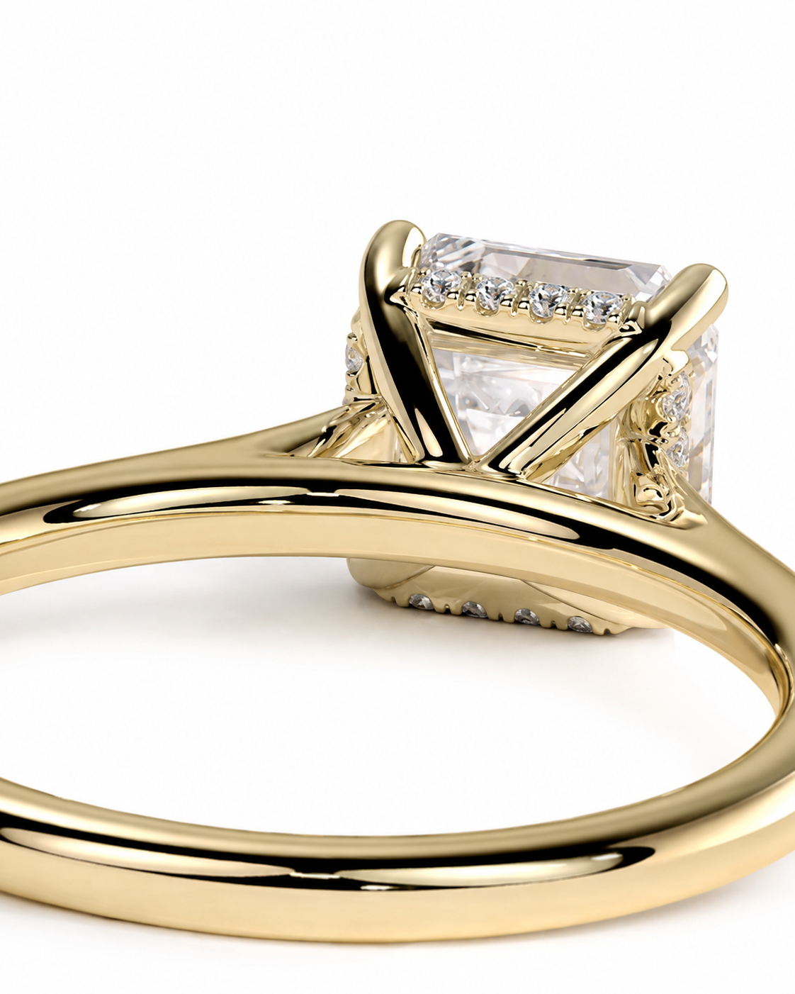 color_10K_YG, color_14K_YG &&	
A close-up shot of a yellow gold ring featuring a large rectangular clear gemstone in a prong setting, with small accent diamonds along the sides, on a white background.