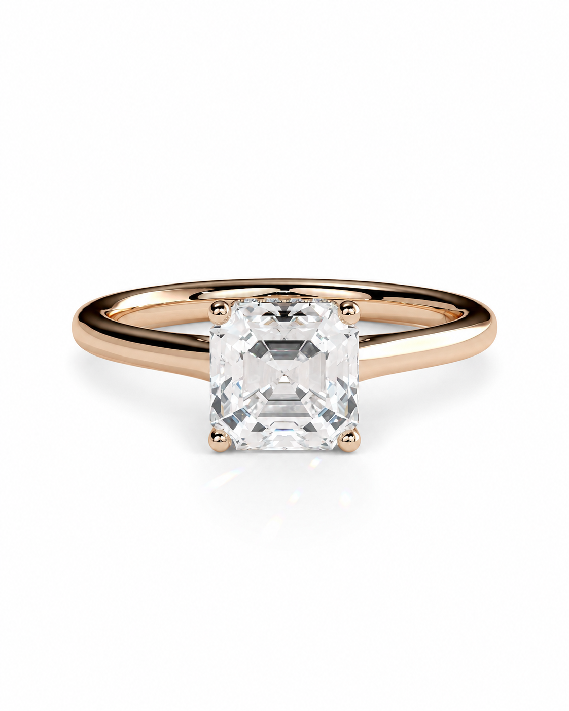 color_10K_RG, color_14K_RG &&	A rose gold solitaire engagement ring featuring a large, square-cut clear gemstone in a four-prong setting, shown on a clean white background.