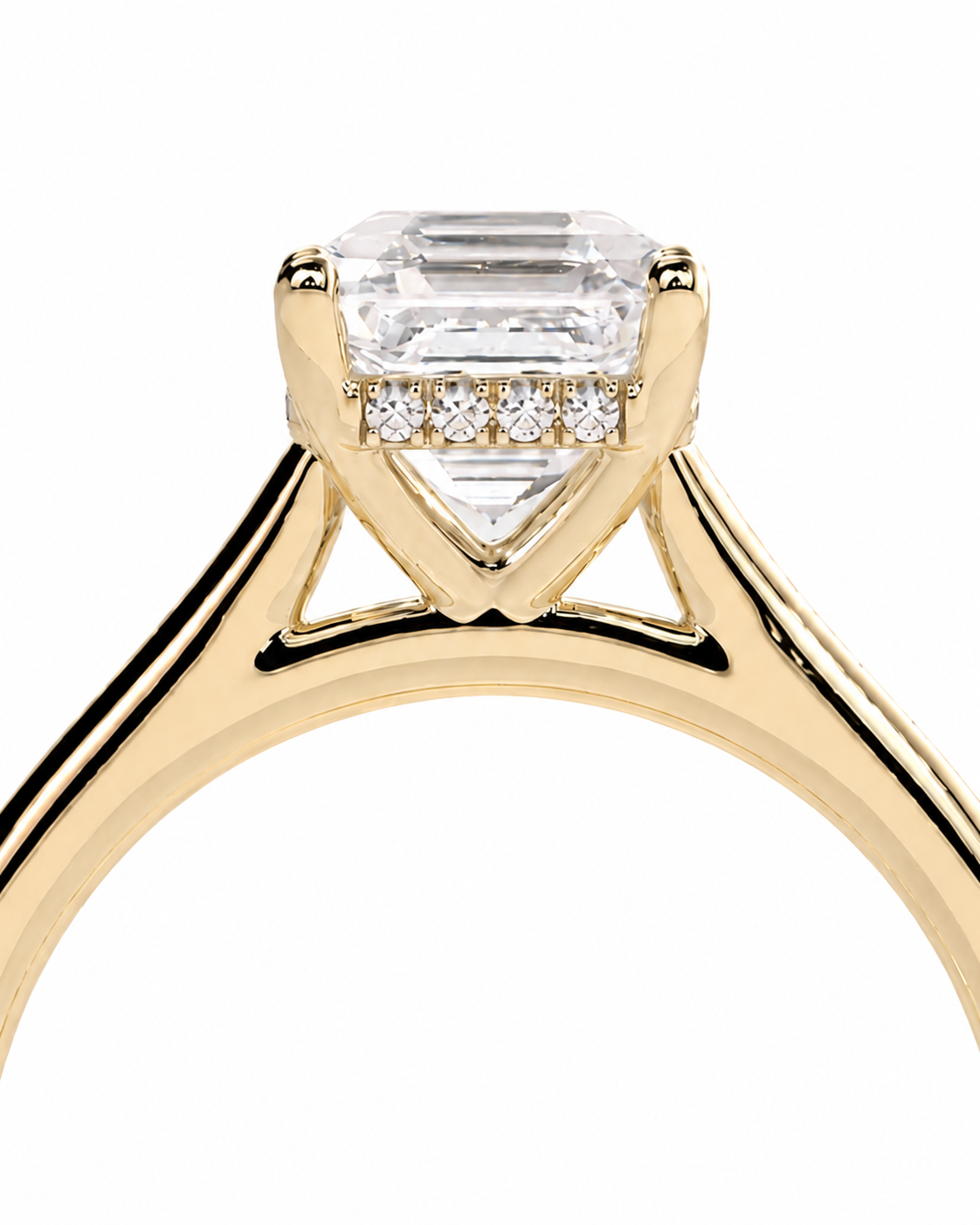 color_10K_YG, color_14K_YG &&	
A close-up of a yellow gold solitaire engagement ring featuring a large rectangular emerald-cut clear center stone and three small round-cut stones in a row beneath the main setting, shown on a plain white background.
