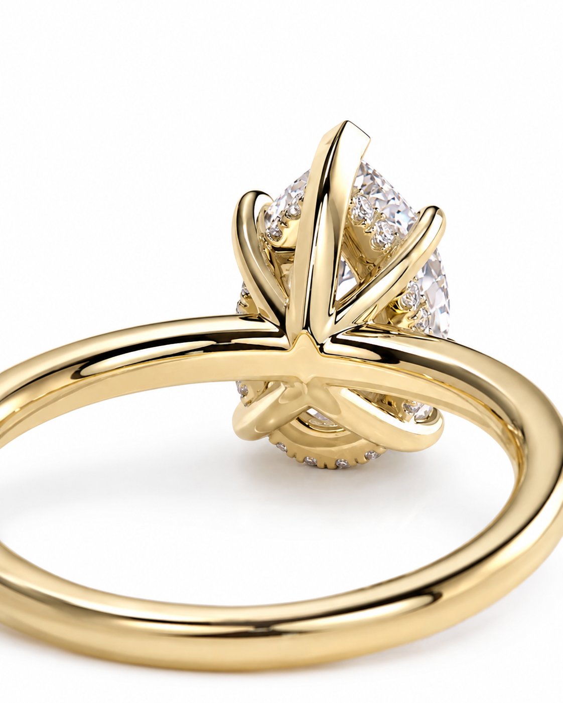 color_10K_YG, color_14K_YG &&	
A close-up shot of a gold ring featuring a pear-cut diamond center stone and a halo of smaller diamonds, set against a clean white background.
