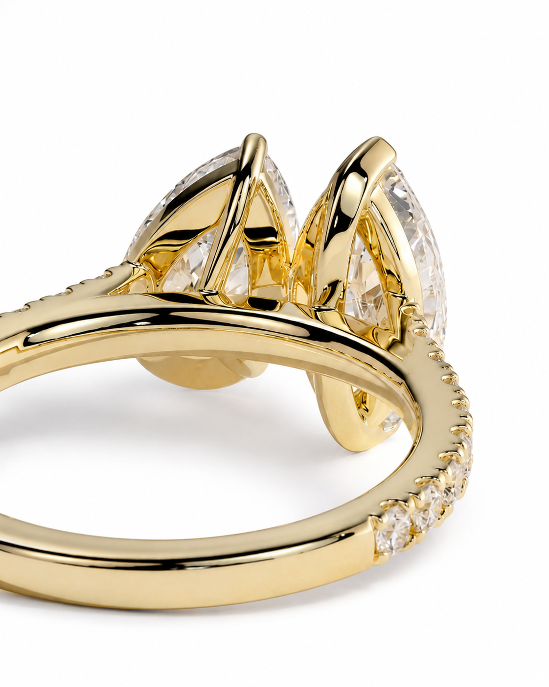 color_10K_YG, color_14K_YG &&	
A close-up of a gold ring featuring marquise-cut clear gemstones in a leaf-like cluster setting, with a polished band accented by small pave stones, shown on a white background.